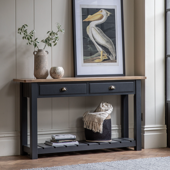 A Buckland Console Table from Kikiathome.co.uk with two drawers and a framed picture is the perfect addition to any interior decor or home furniture.