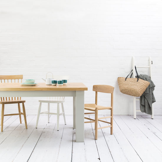 A Farmhouse Rustic Oak Dining Table and chairs by Kiki in a white room for home furniture.
