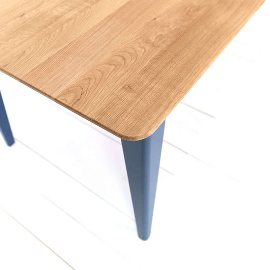 A farmhouse table with blue legs, perfect for home furniture and interior decor.