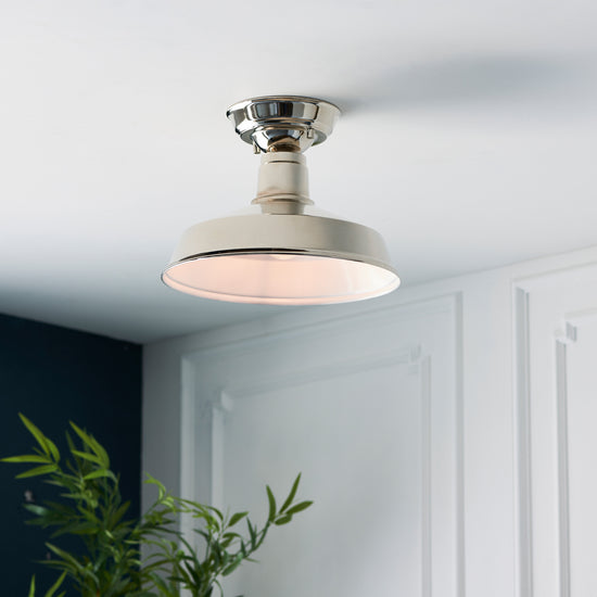 A Darton 1 Ceiling Light by Kikiathome.co.uk enhancing the interior decor of a room with a plant.
