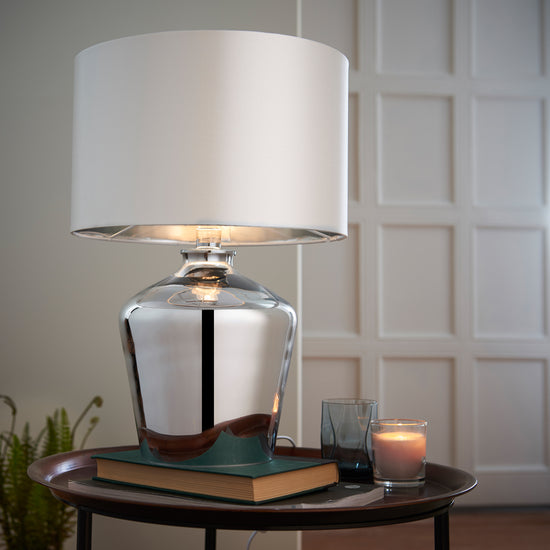 A Waldorf Table Lamp by Kikiathome.co.uk, enhancing interior decor on a table next to a book.
