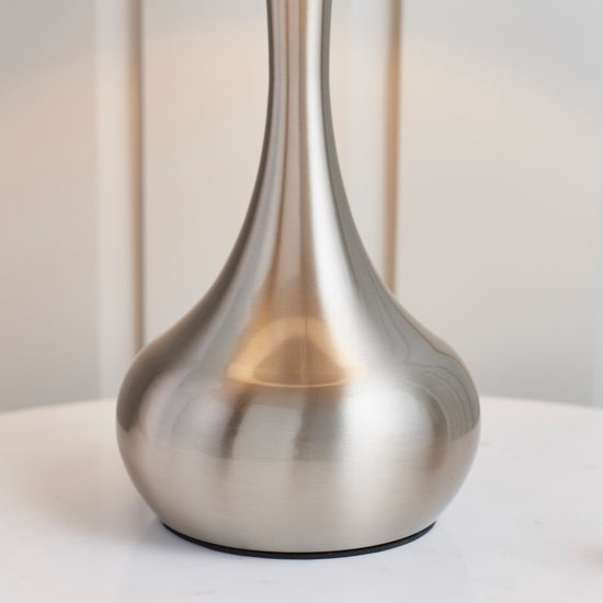 A Piccadilly Table Lamp Nickel & Dark Grey by Kikiathome.co.uk on a white table, perfect for interior decor.