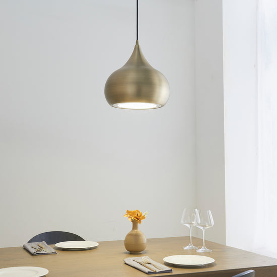 A dining room furnished with home furniture and adorned with the Kikiathome.co.uk Brosser Pendant Light Antique Brass.