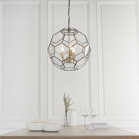A dining room with a Miele 3 Pendant Light Antique Brass hanging over a table from Kikiathome.co.uk for interior decor.