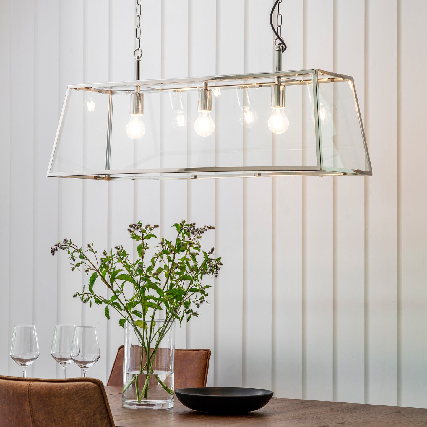 A dining room showcasing interior decor with a Hurst 3 Pendant Light Nickel from Kikiathome.co.uk.