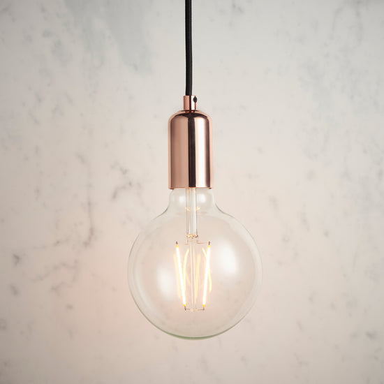 A Copper Pendant Light by Kikiathome.co.uk hanging on a marble wall for interior decor.