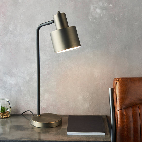 A Mayfield Table Lamp by Kikiathome.co.uk adds elegance to the interior decor, placed on a table next to a leather chair.