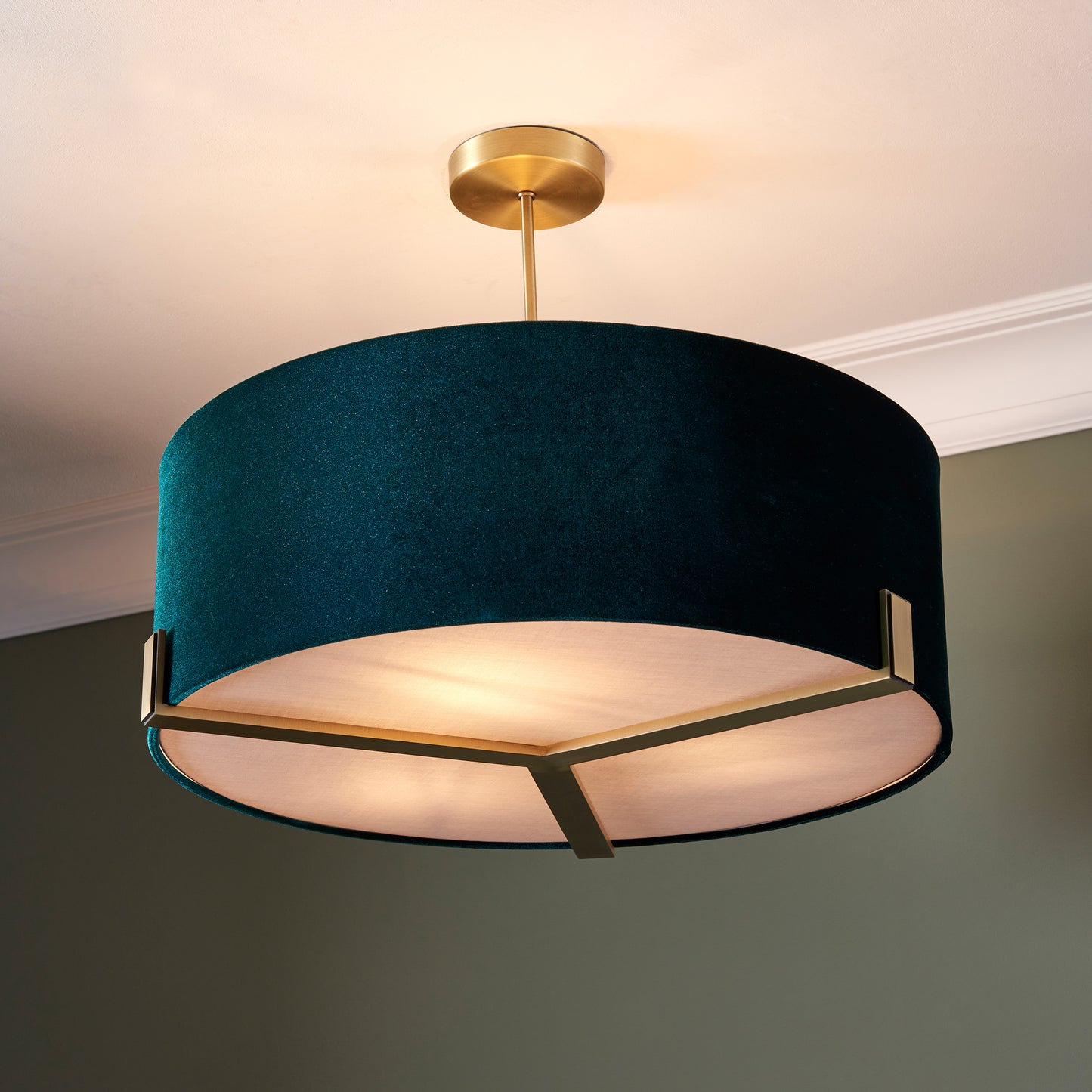 A Hayfield Pendant Light with a green velvet shade, perfect for home decor.