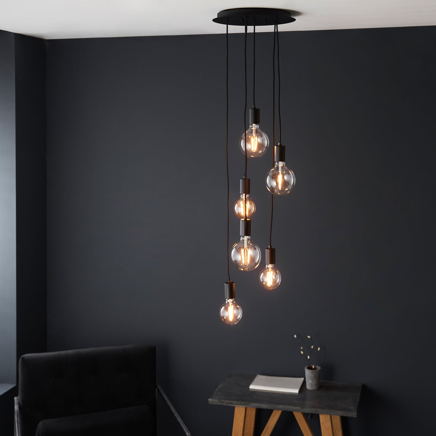 Five Studio 6 Pendant Light Matt Black enhancing interior decor, hanging from a black ceiling.