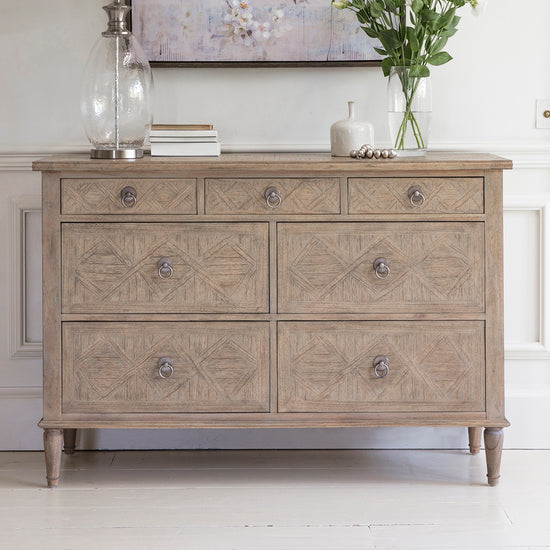 A Belsford 7 Drawer Chest 1300x450x885mm by Kikiathome.co.uk showcased with interior decor and home furniture.