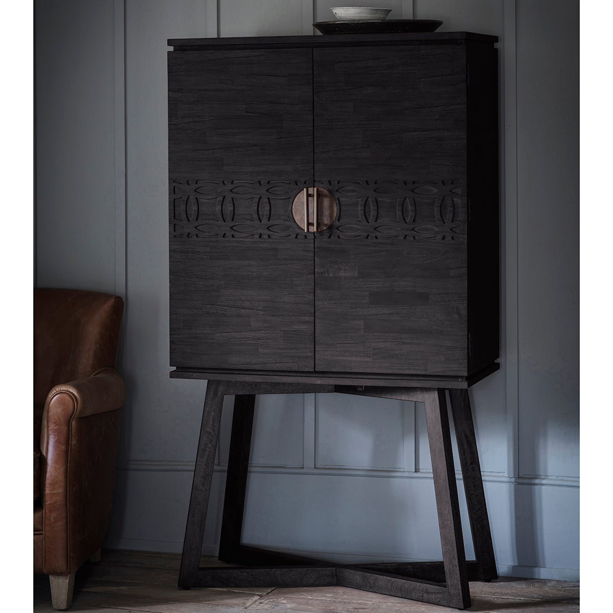 A Dartington Boutique Cocktail Cabinet on a wooden stand in a room, perfect for home furniture and interior decor.