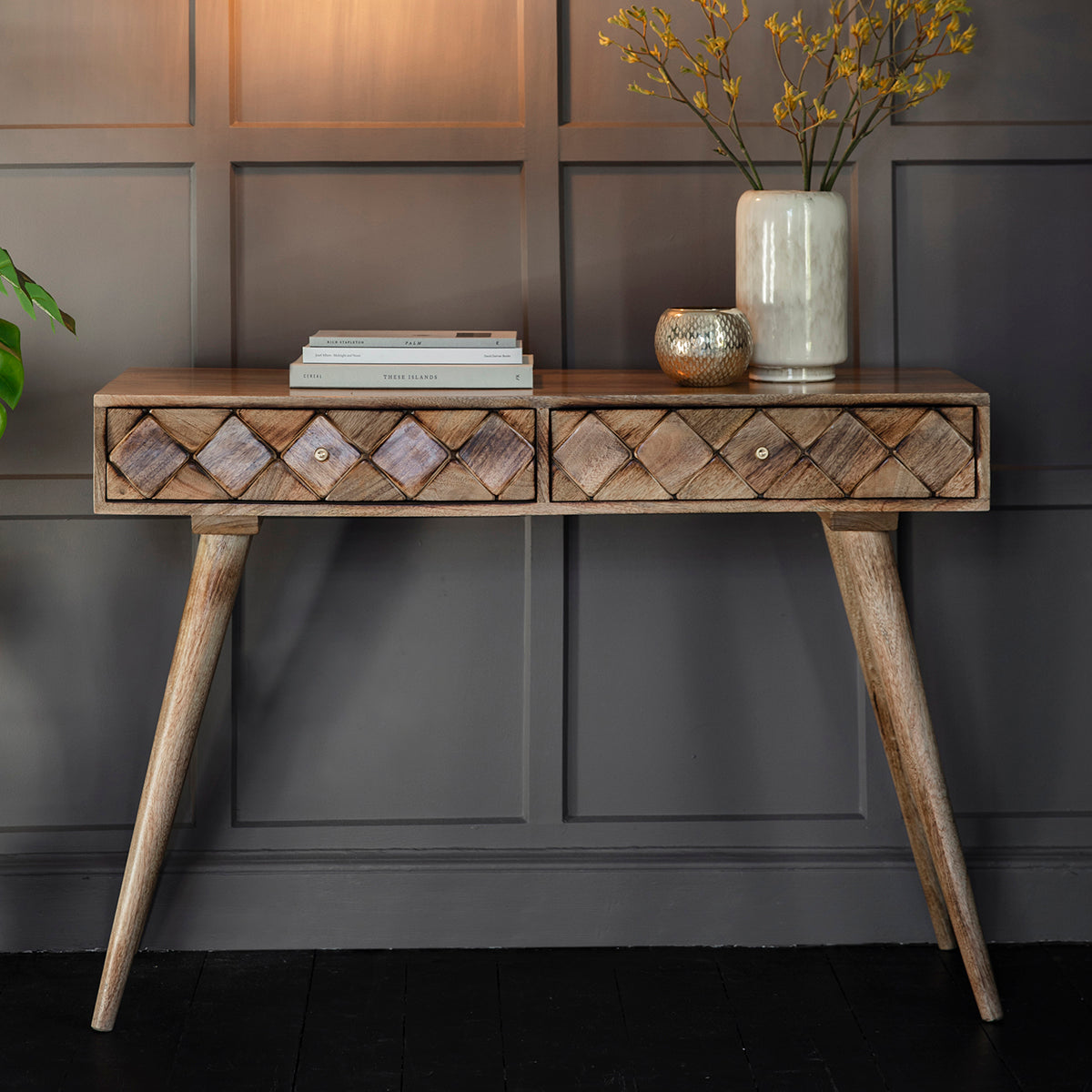 A Tuscany Console Table by Kikiathome.co.uk in front of a wall, adding interior decor to the home furniture.