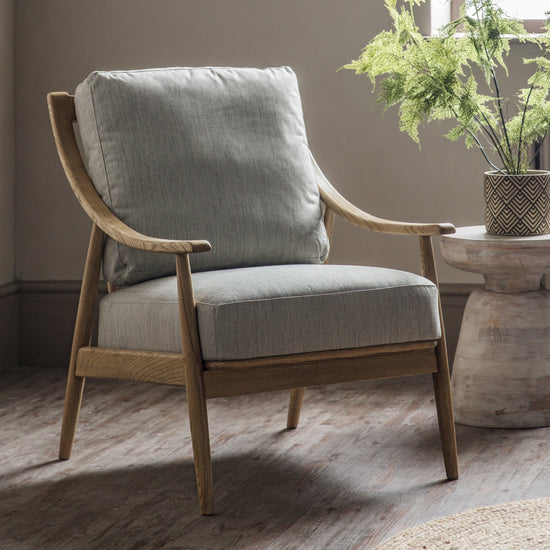 A Reliant Armchair Natural Linen 620x830x880mm by Kikiathome.co.uk, an interior decor home furniture piece, in a room with a plant in front of it