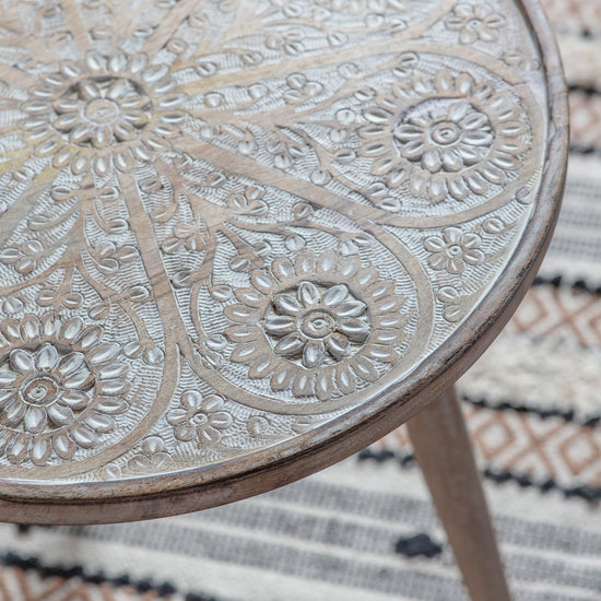 An ornately carved Bantham side table by Kikiathome.co.uk, perfect for interior decor and home furniture, placed on a rug.