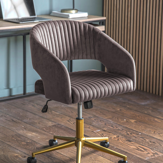 A Murray Swivel Chair Grey Velvet office chair for home furniture on a wooden floor.