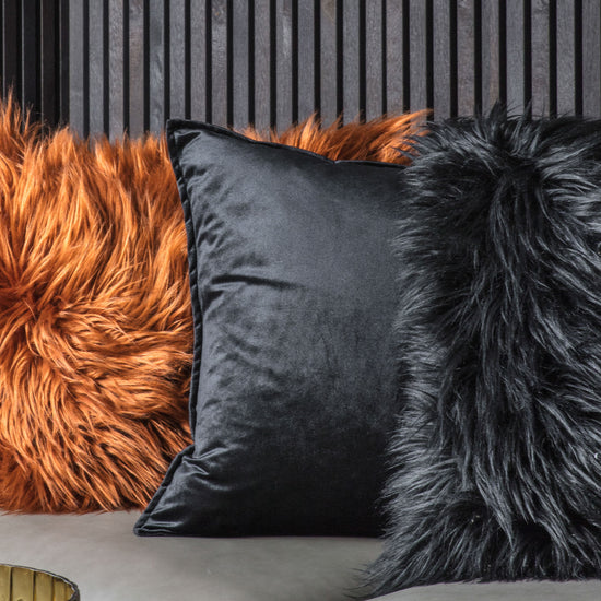 Meto Velvet Oxford Cushion in Black 580x580mm incorporates interior decor on a sofa.