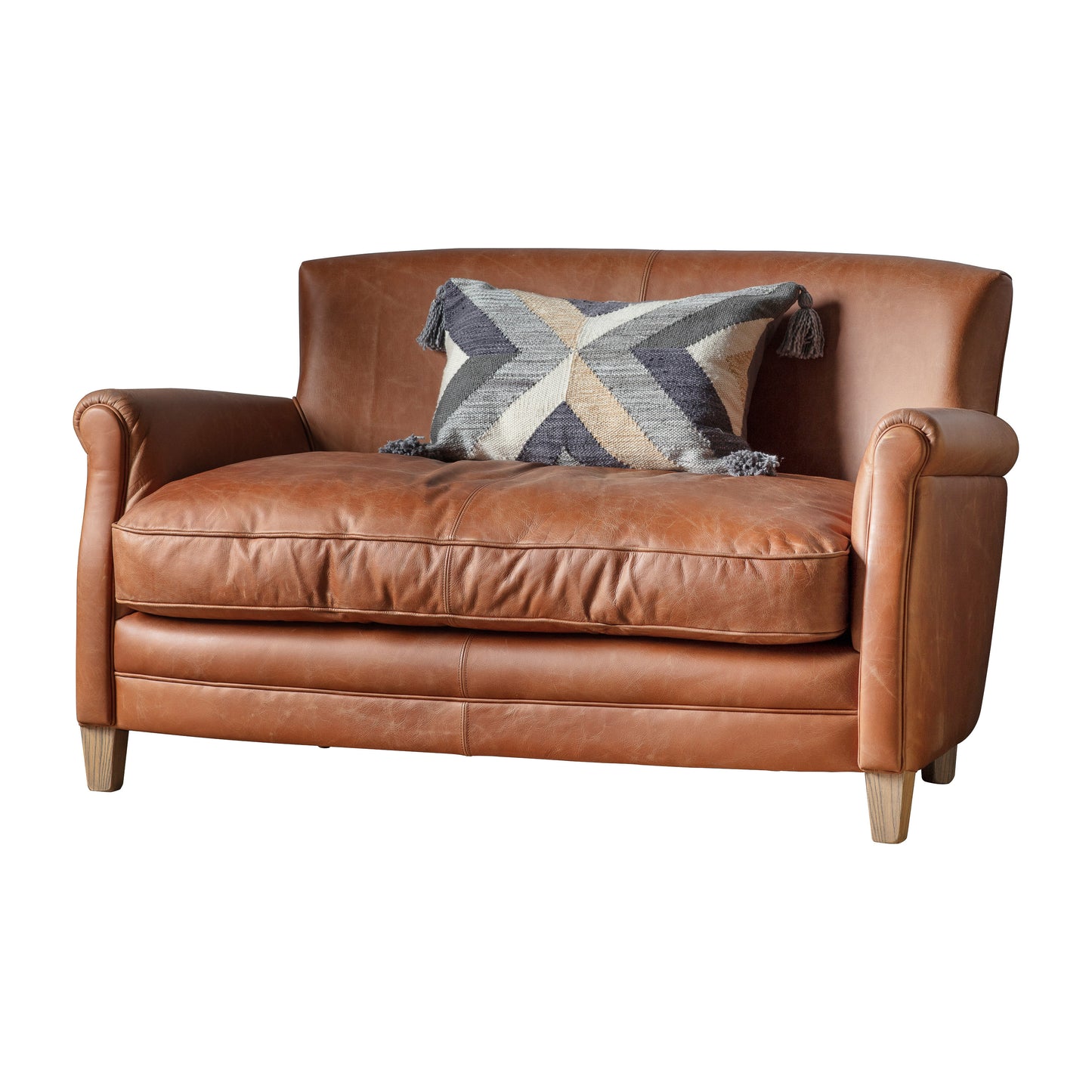 Interior decor, Home furniture: A vintage brown leather bear sofa featuring a geometric pillow sourced from Kikiathome.co.uk.