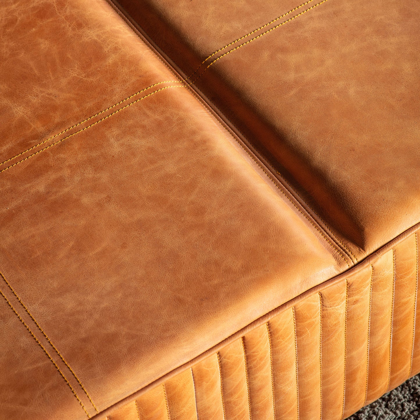 A close up of a Cornwood Slab Brown Leather 1200x1200x300mm couch for interior decor and home furniture.