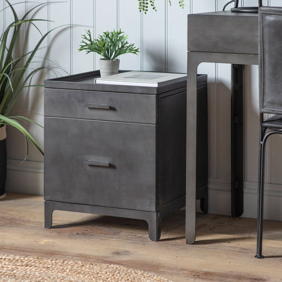 A Kikiathome.co.uk Ottinge 2 Drawer Pedestal with a plant next to it, perfect for interior decor and home furniture.
