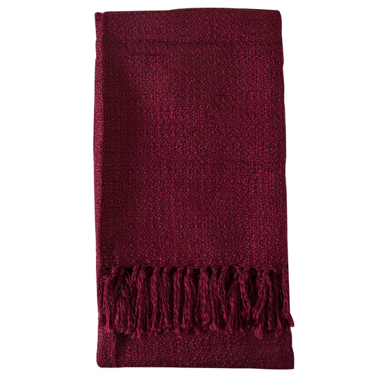 A textured acrylic throw in claret color with fringes, perfect for interior decor and home furniture.