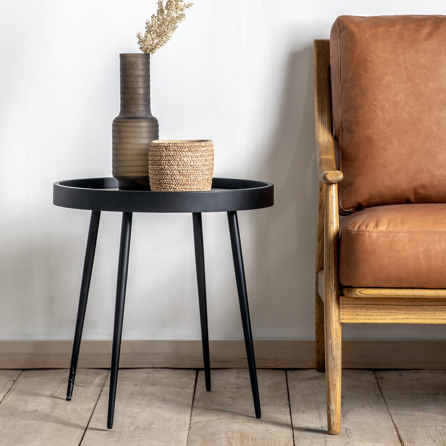 A Pelham Side Table 500x500x500mm from Kikiathome.co.uk, an interior decor piece, next to a brown leather chair.
