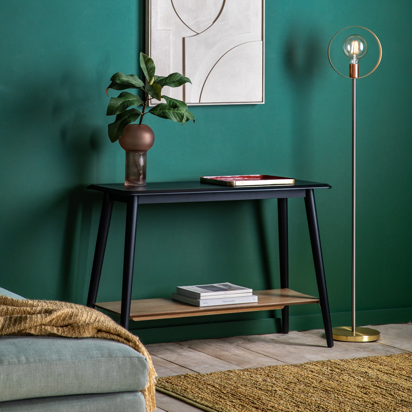 A living room with green walls and the Maddox Console Table with Shelf 110x750x40mm by Kikiathome.co.uk, enhancing interior decor through home furniture.