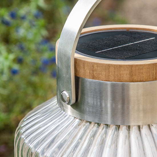 An Averton LED Solar Lantern Small with a wooden handle for interior decor.