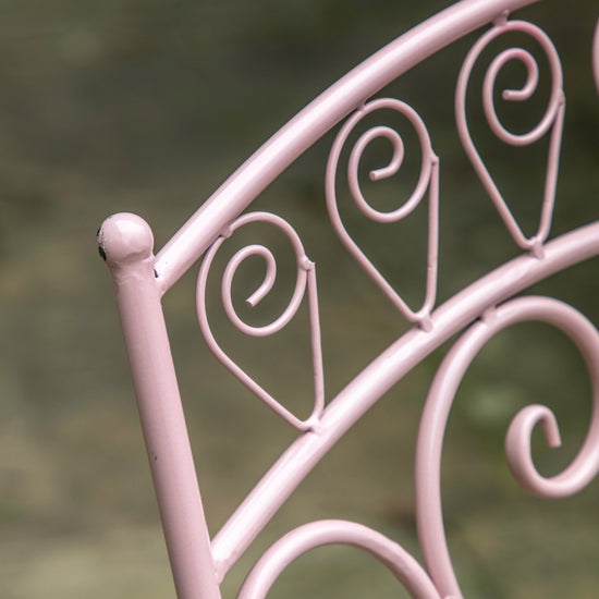 A close-up of the Coral Roborough 2 Seater Bistro Set, a pink metal garden chair featured on Kikiathome.co.uk.