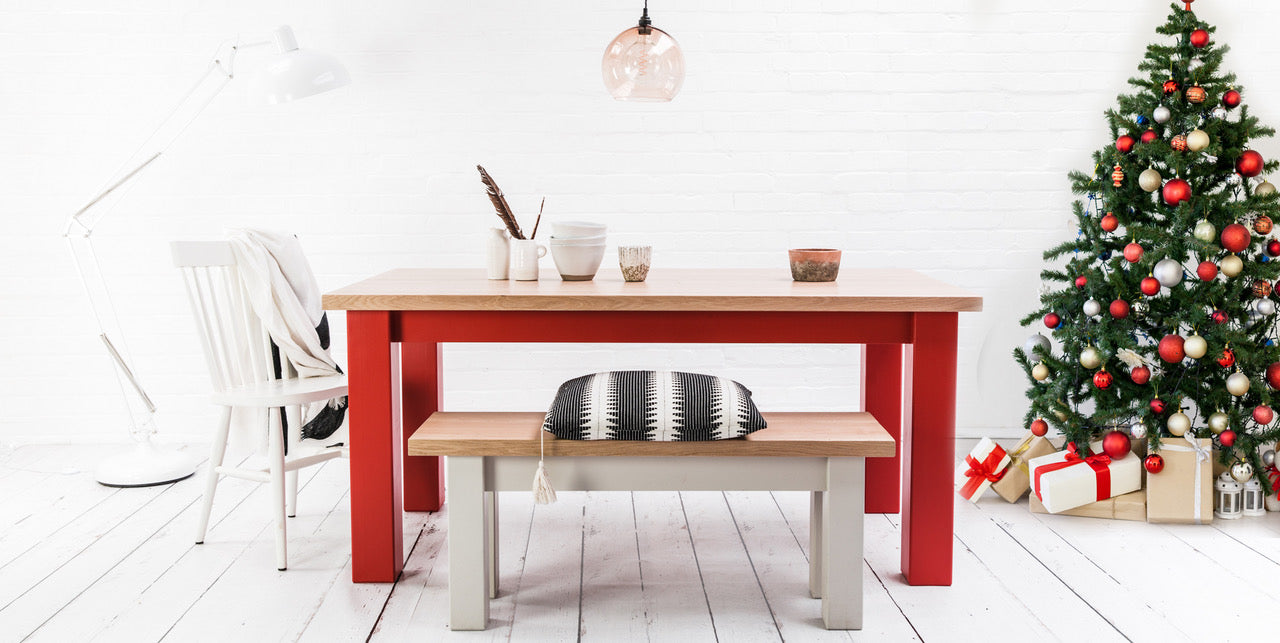 Dining table with red legs in a Christmas environment 