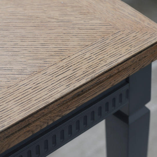 A close up of a home furniture Ponsworthy Ext Dining Table Storm 1860/2360x900x760mm with black legs.
