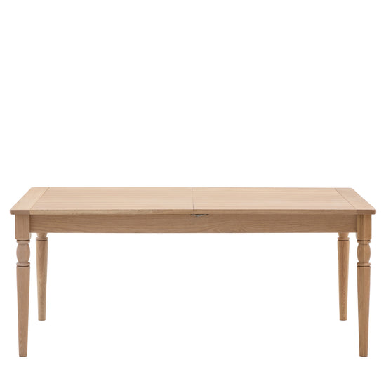 A Buckland Extending Dining Table with a wooden top, perfect for home furniture and interior decor.