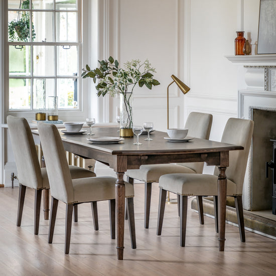 A dining room with an elegant Manaton Extending Dining Table and chairs, perfect for enhancing home furniture and interior decor.