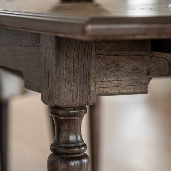 Close up of the legs of a Kikiathome.co.uk Manaton Extending Dining Table, an interior decor piece.