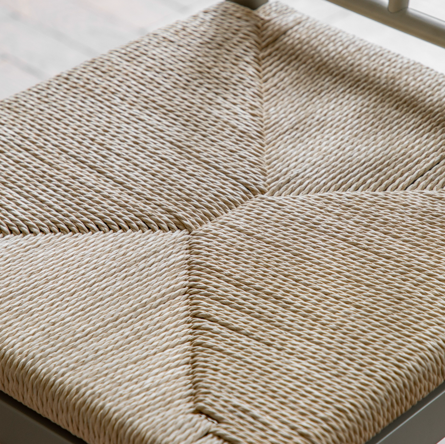 A close up of a Buckland Dining Chair 2pk in Prairie by Kikiathome.co.uk with a woven seat, perfect for interior decor.