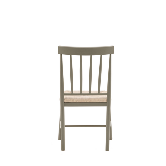 A Buckland Dining Chair 2pk in Prairie from Kikiathome.co.uk, enhancing interior decor with its beige seat against a white background.
