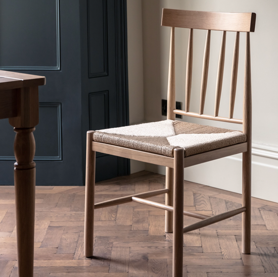 A Buckland Dining Chair 2pk Oak by Kikiathome.co.uk adds style to your interior decor alongside a wooden table.