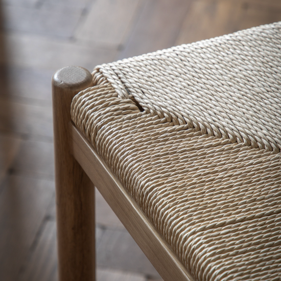 A close up of a Buckland Dining Chair 2pk Oak with a woven seat, perfect for interior decor.