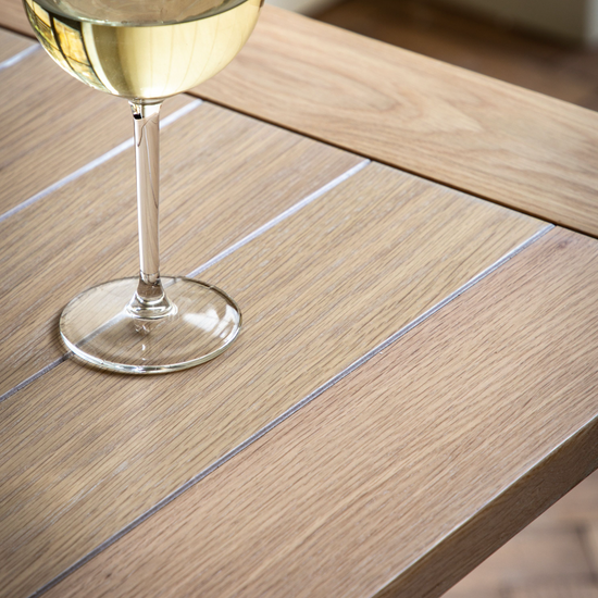A glass of wine on the Buckland Trestle Table 1600x800x750 in Prairie by Kikiathome.co.uk, showcasing interior decor and home furniture.