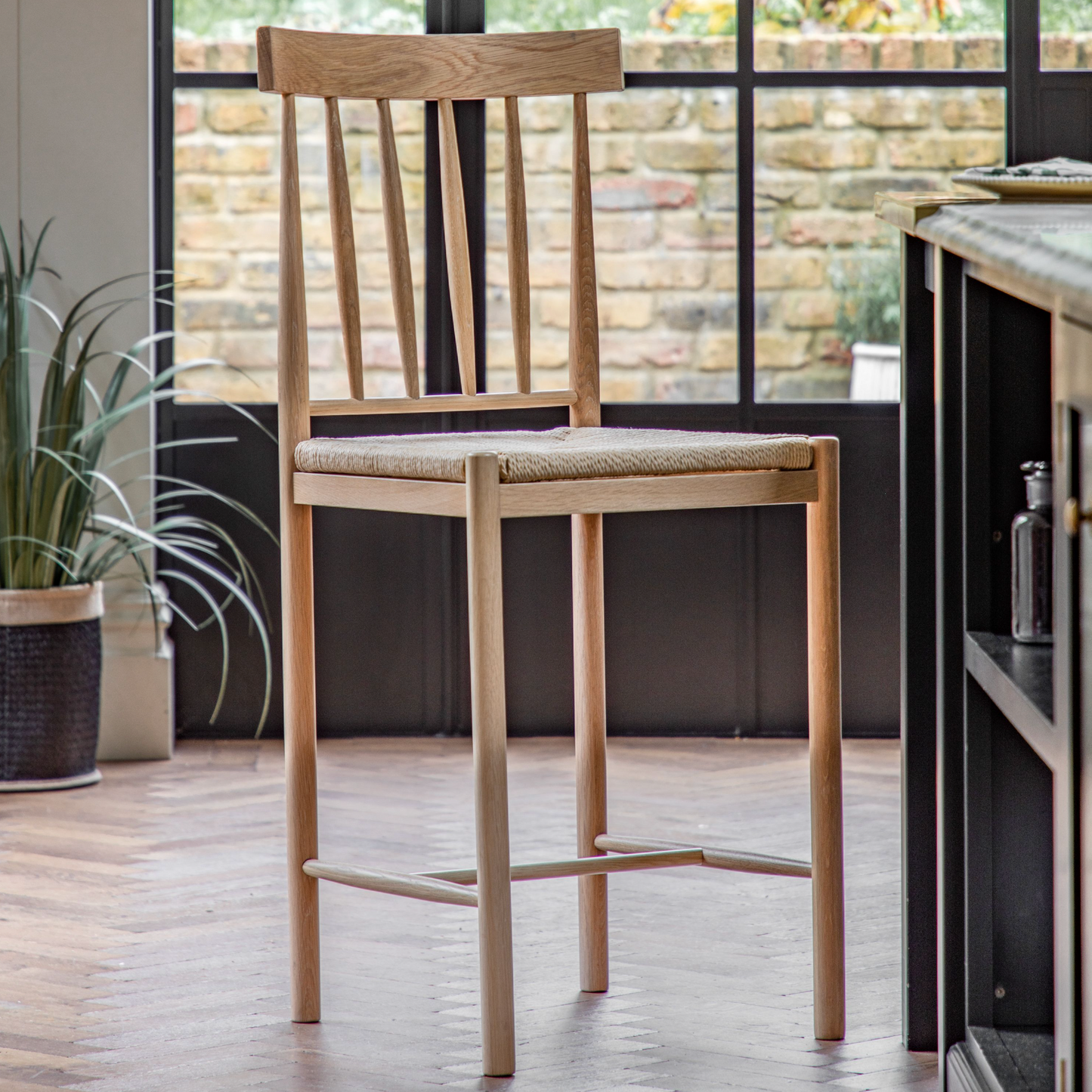 A Buckland Bar Stool in Oak 2pk from Kikiathome.co.uk, perfect for interior decor in a kitchen.