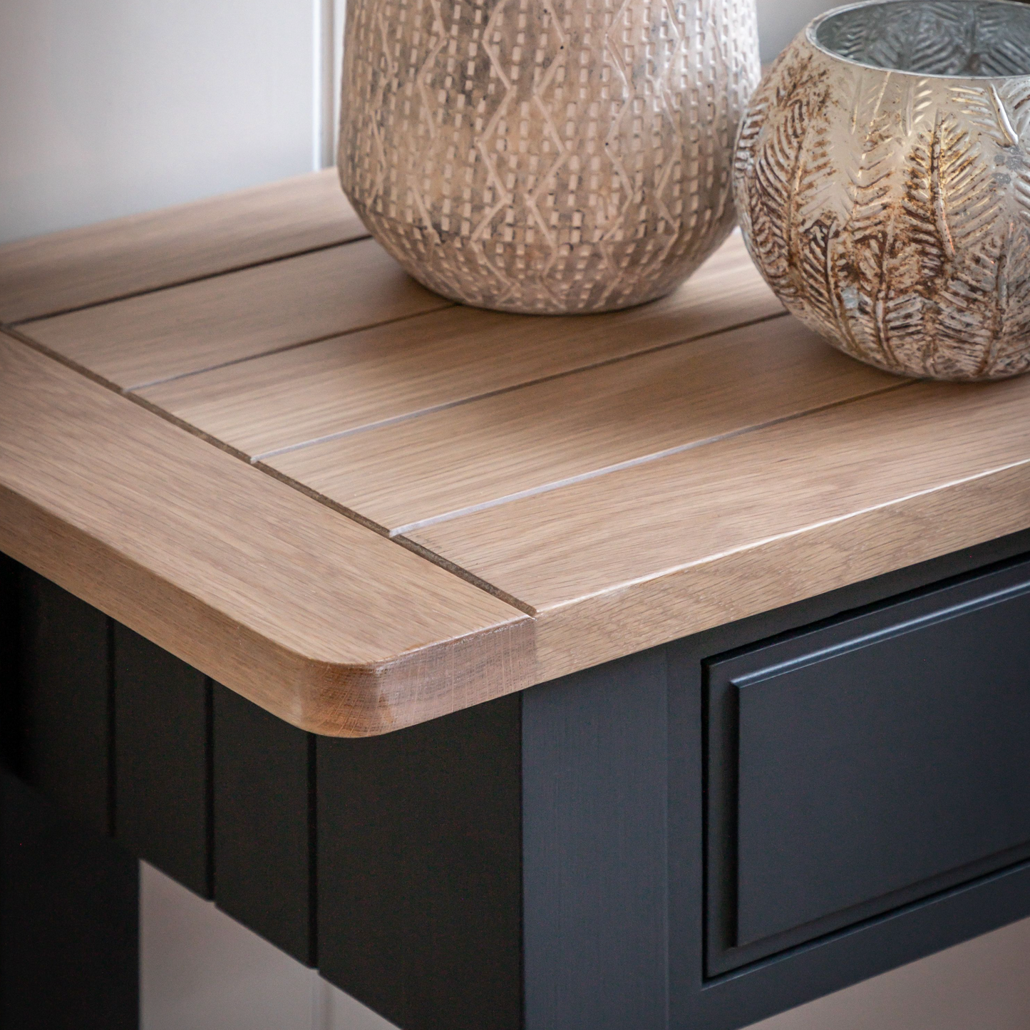 A black Buckland Console Table (w)1400x(d)380x(h)800mm in Meteor from Kikiathome.co.uk complemented with a vase on top perfectly blends home furniture