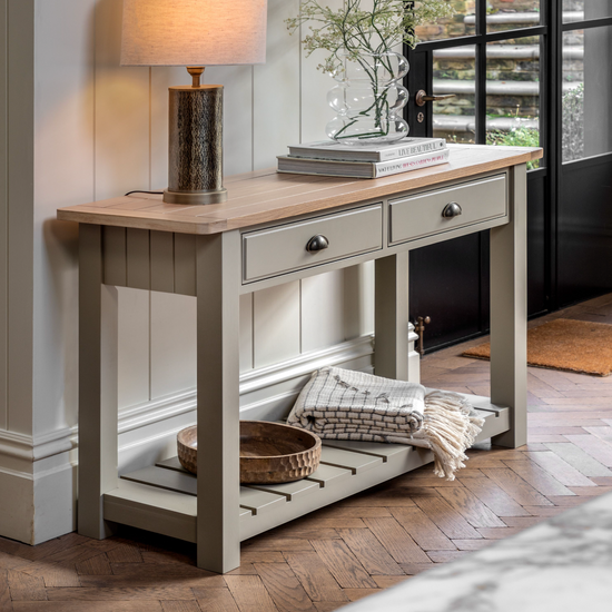 An interior decor home furniture piece, the Buckland Console Table from Kikiathome.co.uk features a Prairie finish with two drawers and a lamp.