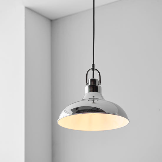 A Crofton 1 Pendant Light from Kikiathome.co.uk adorns an interior room with its stylish design.