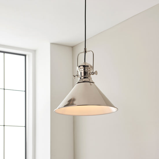 An interior decor pendant light by Kikiathome.co.uk hanging above a window in a room.