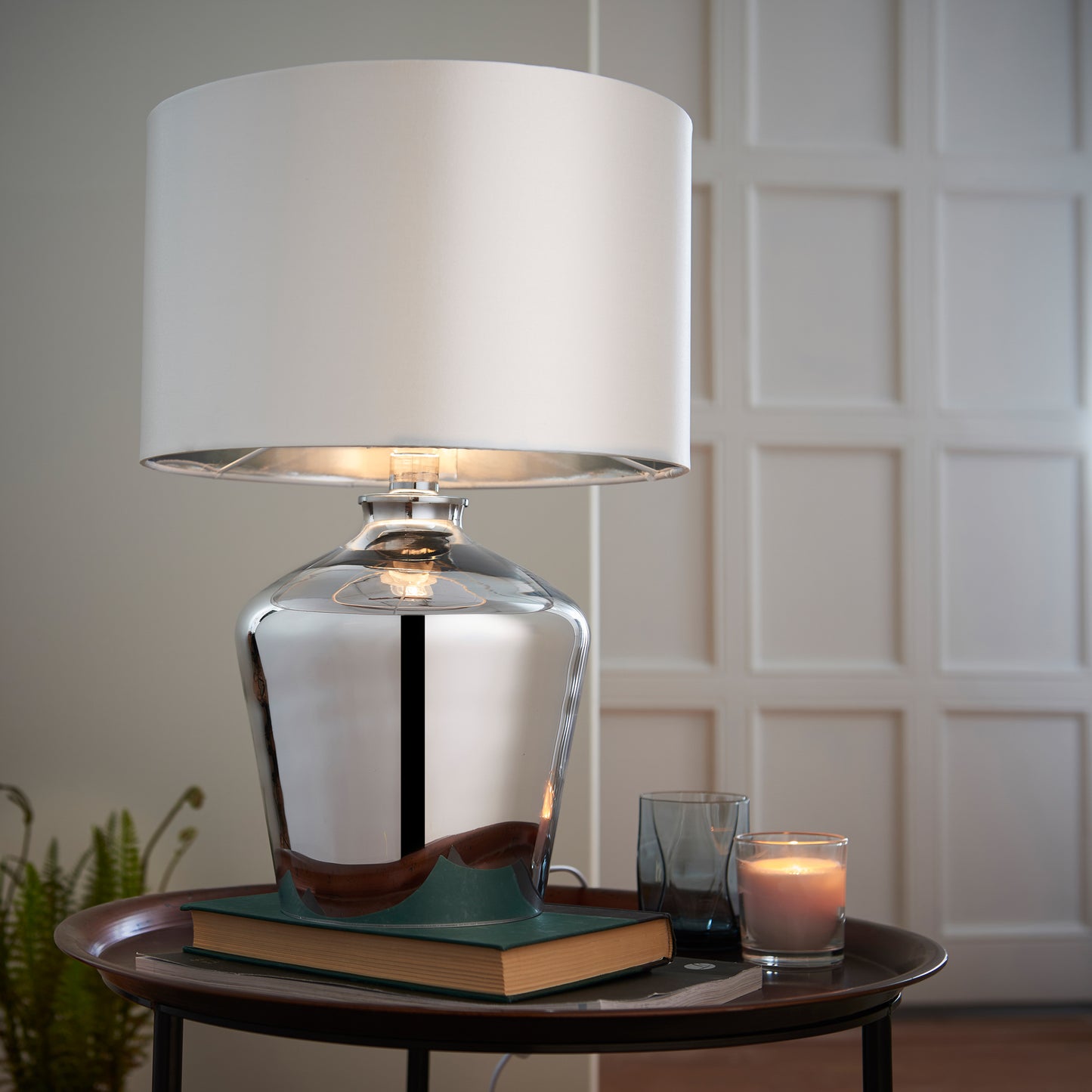 A Waldorf Table Lamp by Kikiathome.co.uk, enhancing interior decor on a table next to a book.
