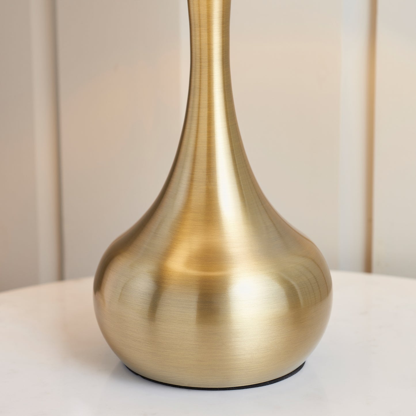 A Piccadilly Table Lamp Brass & Taupe by Kikiathome.co.uk adding elegance to home furniture and interior decor on a white table.