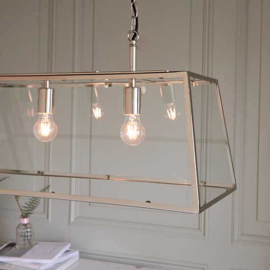 An interior decor pendant light hanging above a desk with three bulbs from Kikiathome.co.uk.