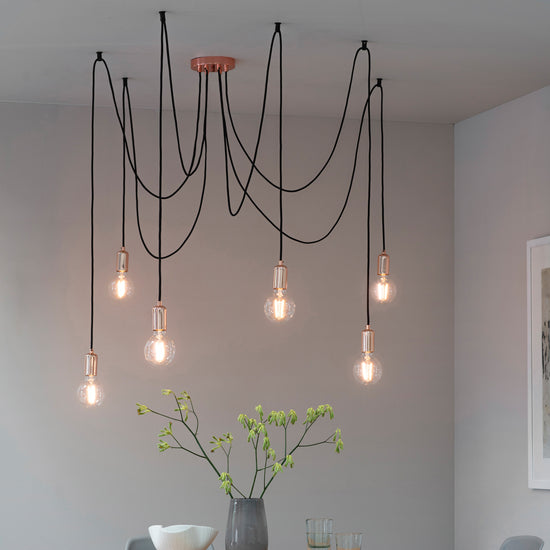 A dining room with several Studio 6 Cluster Pendant Lights, sold by Kikiathome.co.uk, adding home furniture and interior decor.