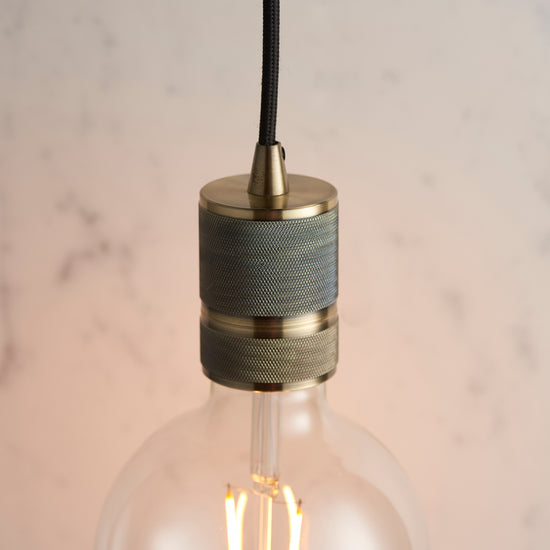 A stylish Urban Pendant Light Antique Brass with a wooden shade, perfect for interior decor.