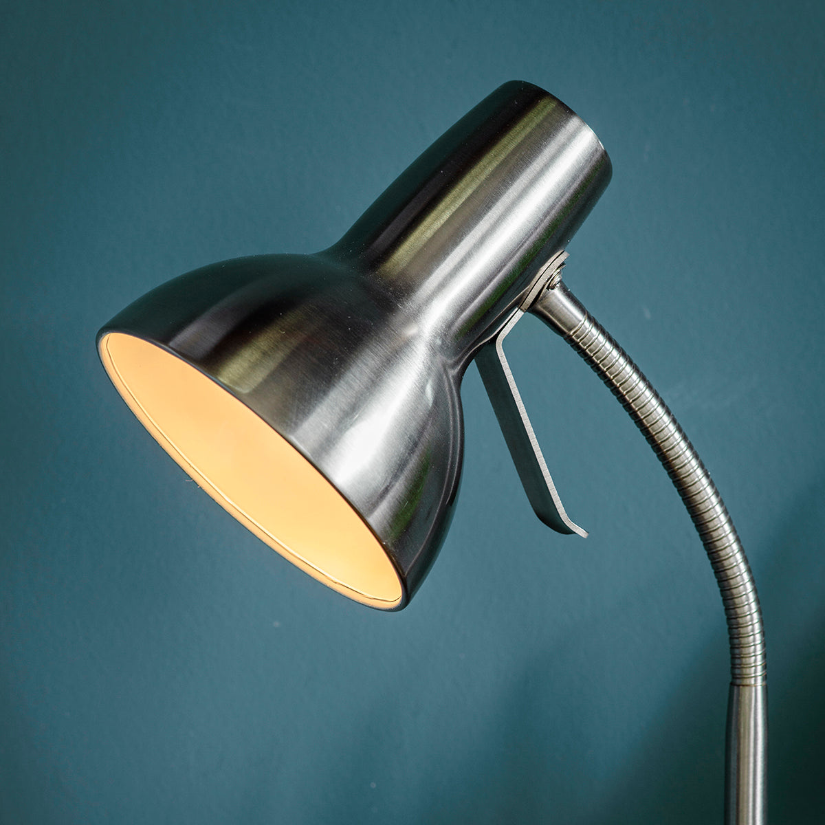 A Bickerton Floor Lamp Nickel by Kikiathome.co.uk adding to the interior decor of a blue wall.