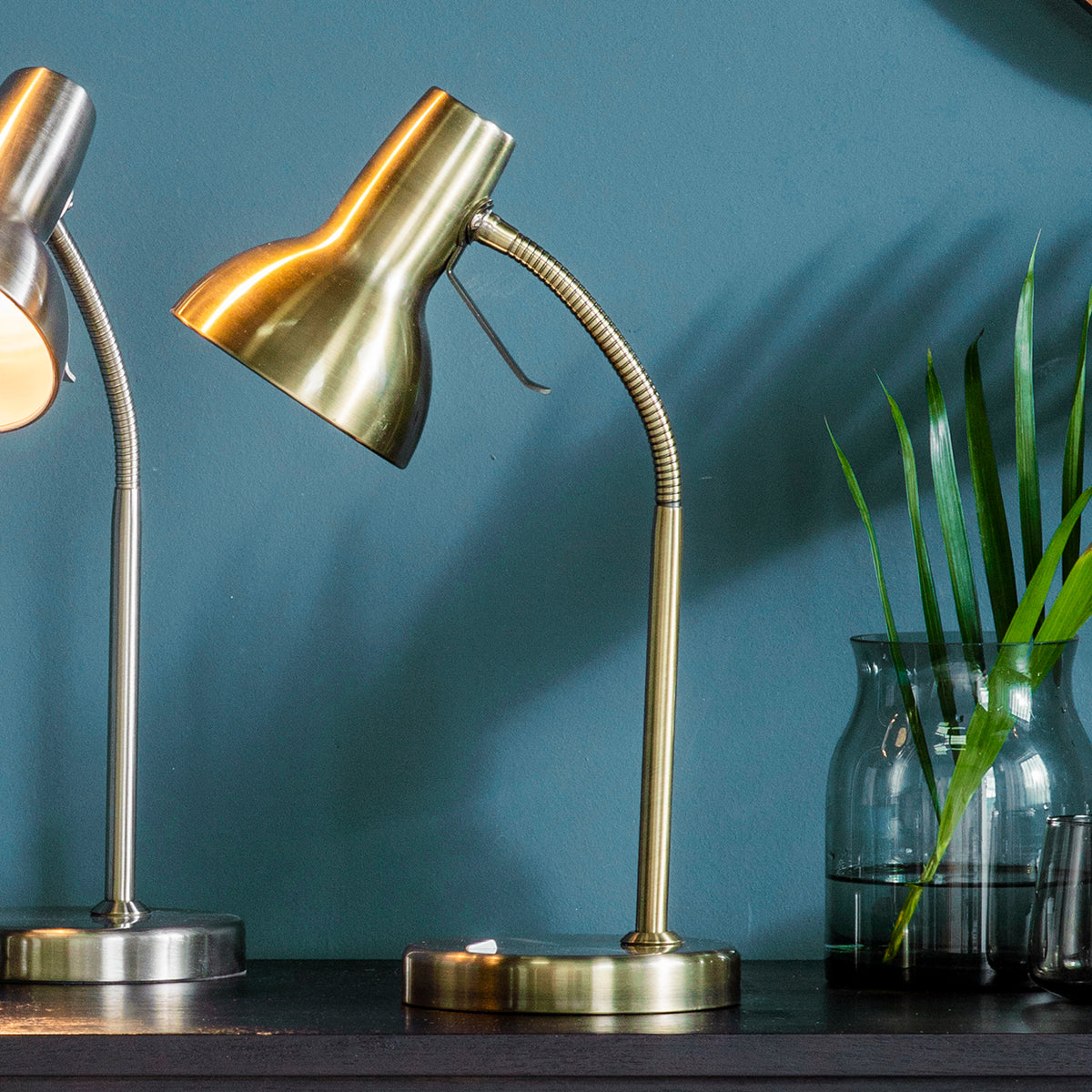 Two Antique Brass USB Table Lamps on a table in front of a blue wall, enhancing interior decor.